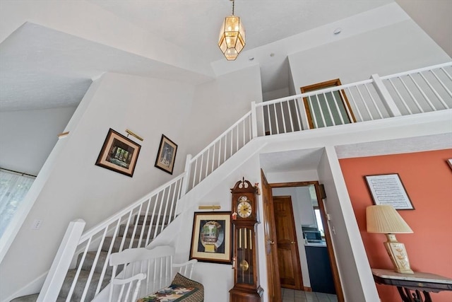 stairs featuring a high ceiling