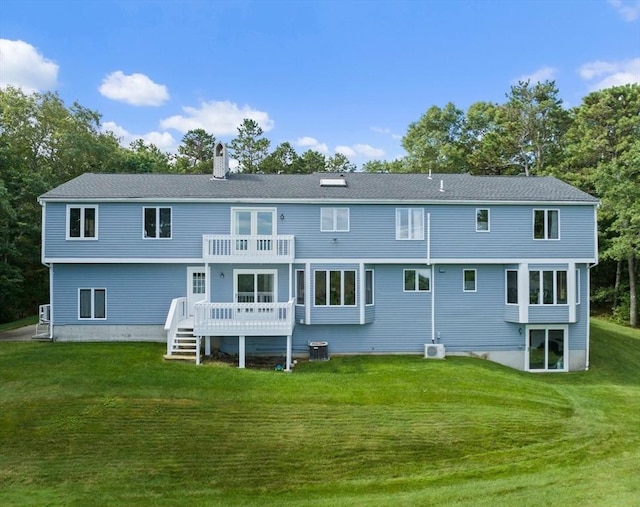 back of property with a yard, cooling unit, a wooden deck, and a chimney