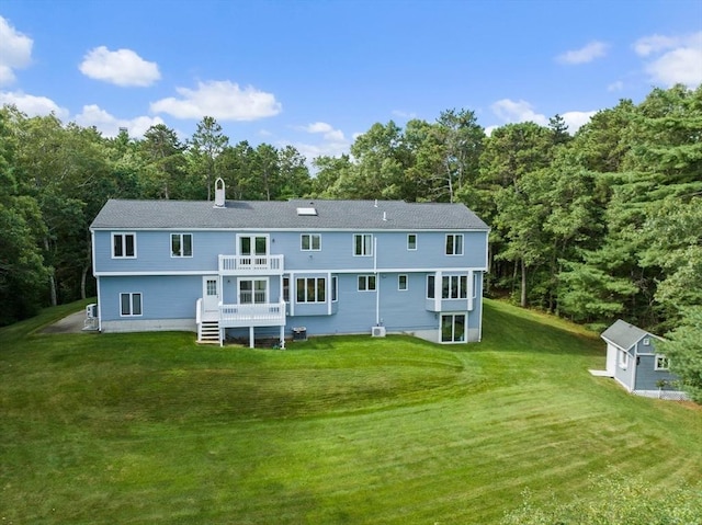 back of property with a yard and a chimney