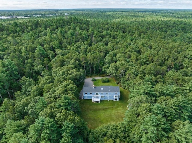 birds eye view of property featuring a forest view