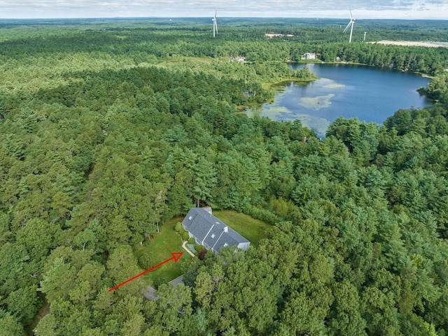 aerial view with a water view and a wooded view