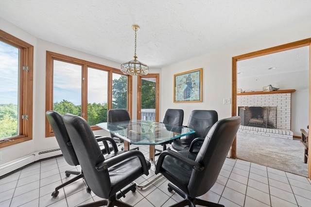 dining space featuring a notable chandelier, a textured ceiling, light tile patterned flooring, and a fireplace