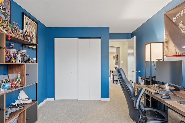 carpeted office space featuring baseboards