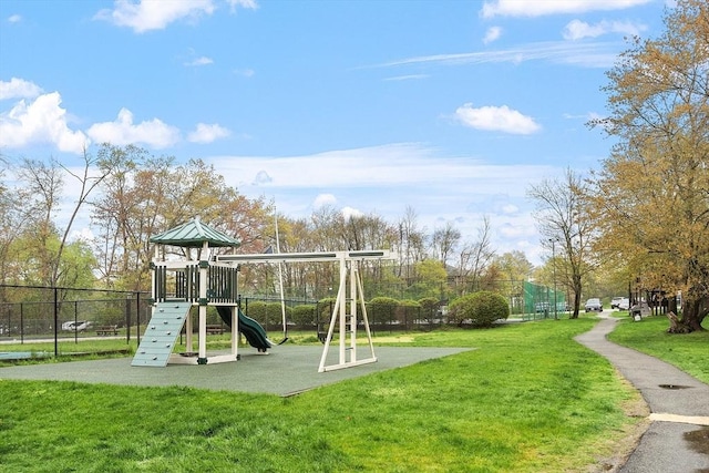 community playground featuring a yard and fence