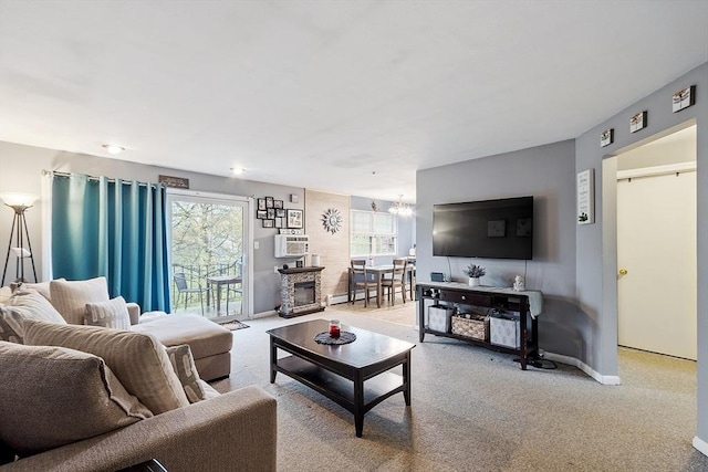 carpeted living room with an inviting chandelier, a wall mounted air conditioner, baseboards, and baseboard heating