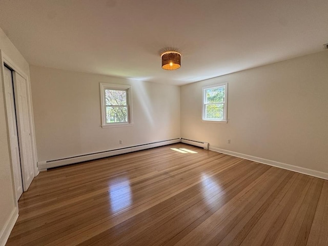 8 Melanie Ln, Mattapoisett, MA 02739 - unfurnished bedroom with a baseboard heating unit, wood finished floors, and baseboard heating