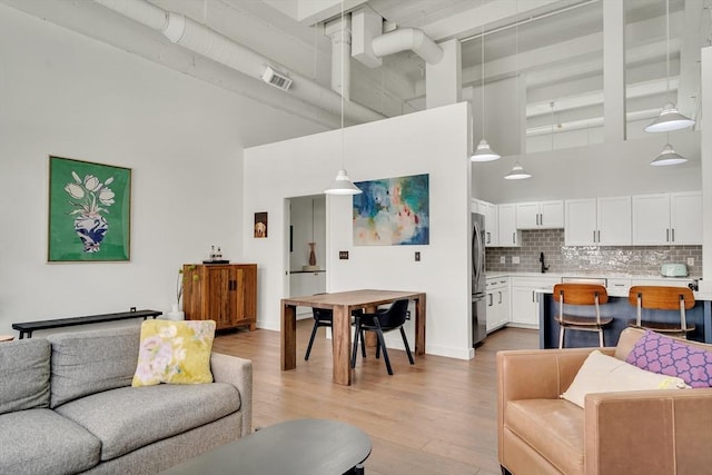 165 Chestnut Hill Ave Unit 3, Boston, MA 02135 - living area featuring a high ceiling and light wood-style flooring