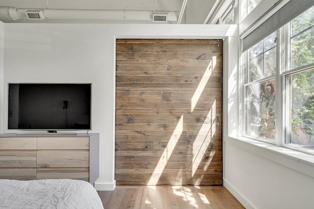 165 Chestnut Hill Ave Unit 3, Boston, MA 02135 - bedroom with multiple windows and wood-type flooring