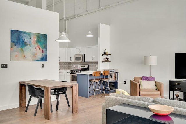 165 Chestnut Hill Ave Unit 3, Boston, MA 02135 - living area with a high ceiling and light wood-style floors