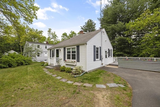 1652 Parker St, Springfield, MA 01128 - view of front of house with a chimney, a front yard, and a shingled roof