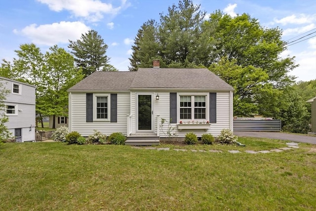 1652 Parker St, Springfield, MA 01128 - view of front facade featuring a front lawn and a chimney
