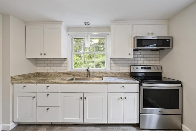 1652 Parker St, Springfield, MA 01128 - kitchen with stainless steel appliances, a sink, white cabinetry, decorative backsplash, and light stone counters