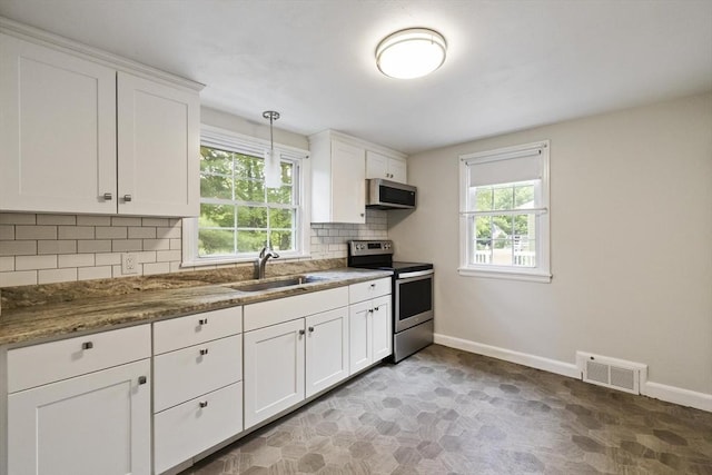 1652 Parker St, Springfield, MA 01128 - kitchen with appliances with stainless steel finishes, a sink, baseboards, and white cabinetry