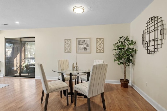 dining space featuring hardwood / wood-style flooring