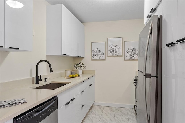 kitchen with sink, stainless steel appliances, and white cabinets