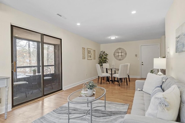 living room with light hardwood / wood-style flooring