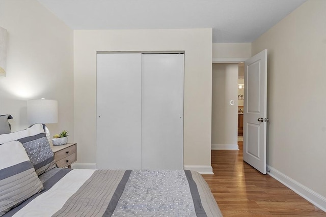 bedroom featuring light hardwood / wood-style floors and a closet