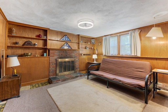 30 Stone St, Bellingham, MA 02019 - living room with wood walls, a fireplace, carpet flooring, a textured ceiling, and built in features