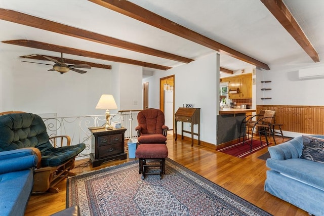30 Stone St, Bellingham, MA 02019 - living area with beamed ceiling, a wall mounted air conditioner, wood finished floors, a ceiling fan, and wainscoting