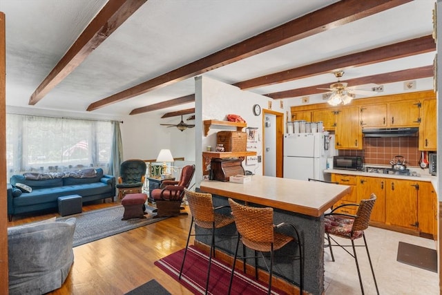 30 Stone St, Bellingham, MA 02019 - kitchen featuring freestanding refrigerator, ceiling fan, light countertops, under cabinet range hood, and beamed ceiling