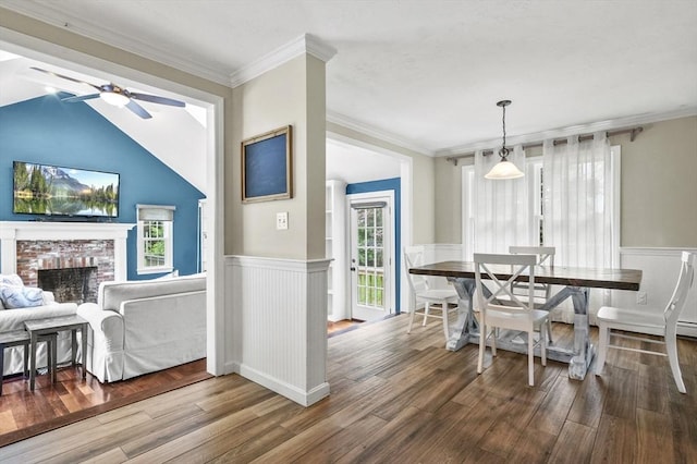 323 School St, Pembroke, MA 02359 - dining area featuring wainscoting, a ceiling fan, a brick fireplace, plenty of natural light, and wood finished floors