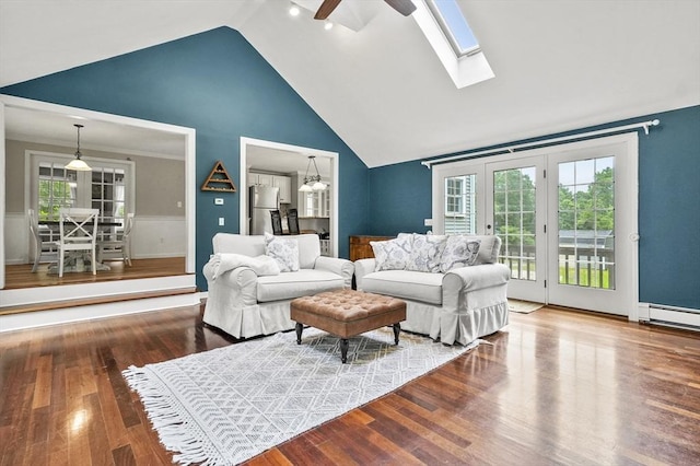 323 School St, Pembroke, MA 02359 - living area featuring ceiling fan, high vaulted ceiling, wood finished floors, a skylight, and a baseboard heating unit