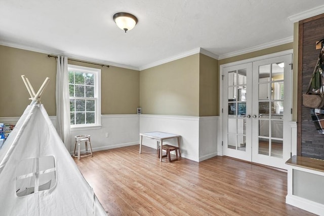 323 School St, Pembroke, MA 02359 - rec room with french doors, wood finished floors, crown molding, and a wainscoted wall