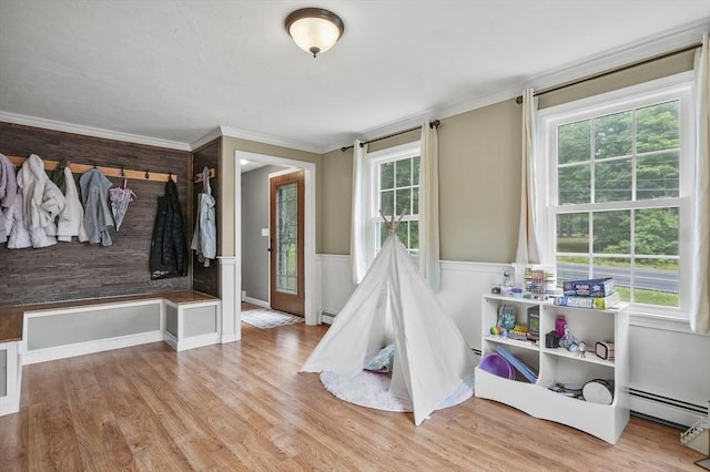 323 School St, Pembroke, MA 02359 - rec room with baseboard heating, wood finished floors, wainscoting, and crown molding