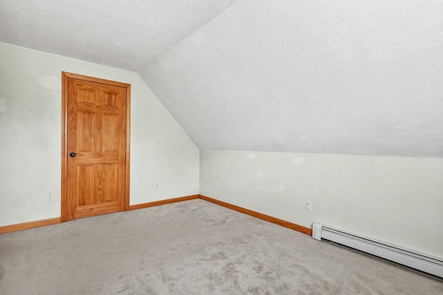 323 School St, Pembroke, MA 02359 - additional living space featuring a baseboard radiator, vaulted ceiling, and carpet flooring