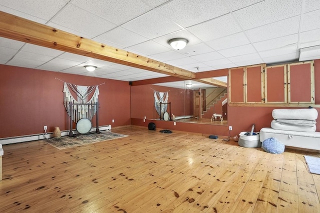 323 School St, Pembroke, MA 02359 - workout room featuring a paneled ceiling, wood-type flooring, and a baseboard heating unit