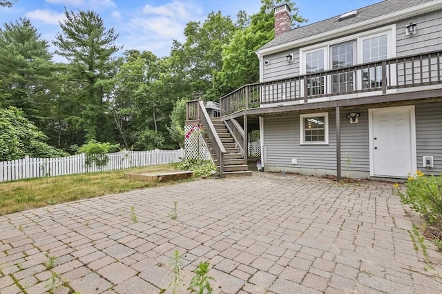 323 School St, Pembroke, MA 02359 - back of property featuring a patio, stairs, a deck, and a chimney