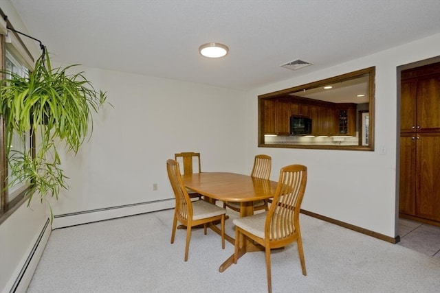80 Vassar Rd, Agawam, MA 01030 - dining area featuring a baseboard radiator and light carpet