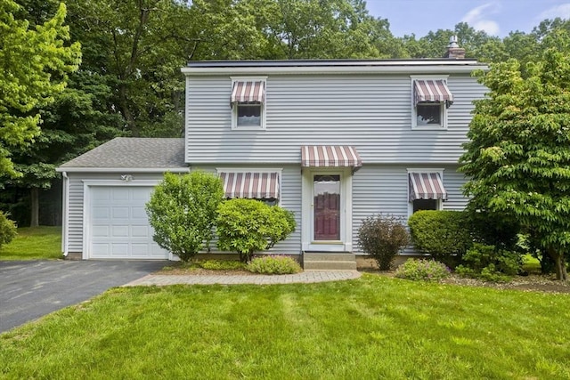 80 Vassar Rd, Agawam, MA 01030 - colonial home featuring a front lawn, asphalt driveway, an attached garage, and a chimney