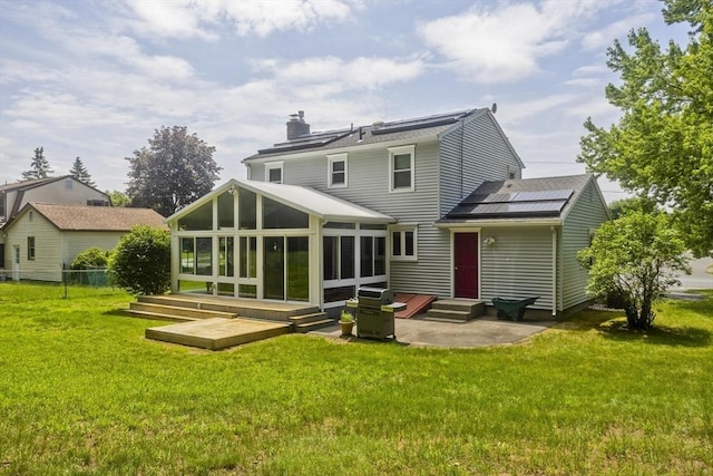 80 Vassar Rd, Agawam, MA 01030 - rear view of property featuring a sunroom, entry steps, a chimney, and solar panels