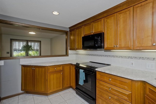80 Vassar Rd, Agawam, MA 01030 - kitchen with black appliances, brown cabinetry, backsplash, light stone counters, and light tile patterned floors