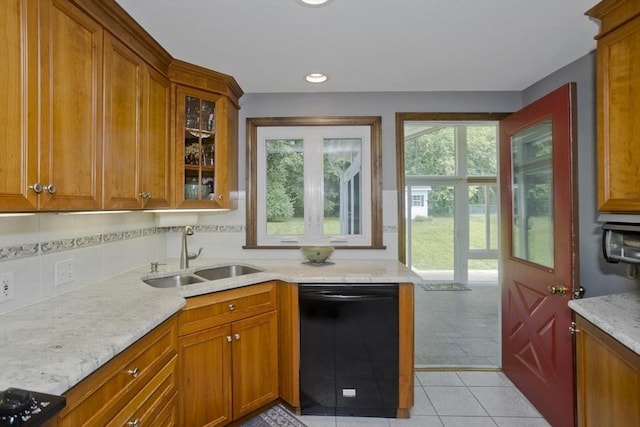 80 Vassar Rd, Agawam, MA 01030 - kitchen featuring black dishwasher, backsplash, brown cabinets, light stone counters, and glass insert cabinets