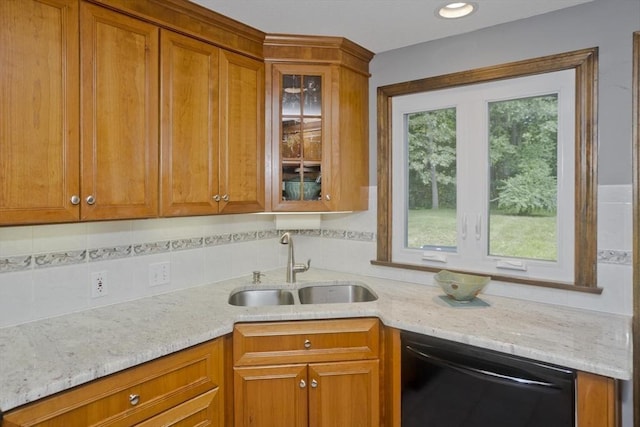 80 Vassar Rd, Agawam, MA 01030 - kitchen with black dishwasher, brown cabinetry, tasteful backsplash, and light stone countertops