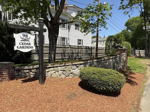 community / neighborhood sign with fence