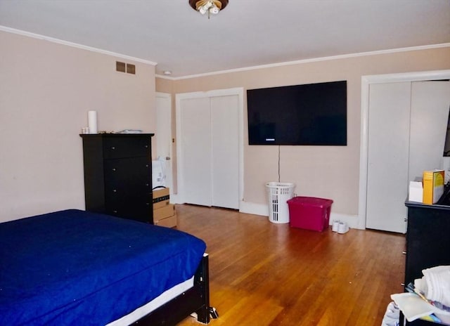 bedroom featuring hardwood / wood-style flooring and crown molding