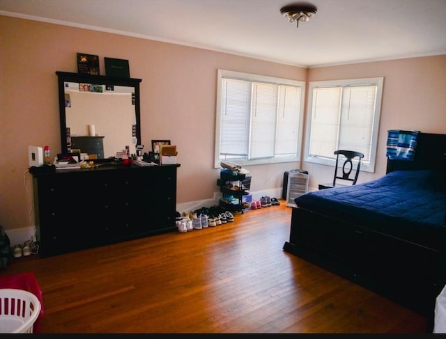 bedroom featuring hardwood / wood-style floors and crown molding