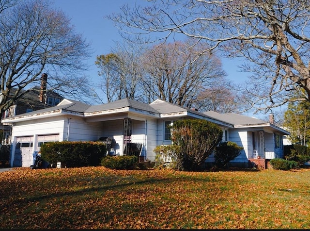 view of home's exterior featuring a yard and a garage