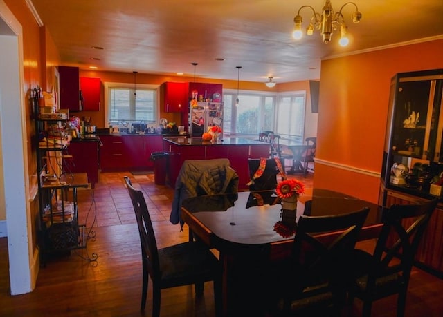 dining room featuring hardwood / wood-style flooring, a wealth of natural light, and a notable chandelier