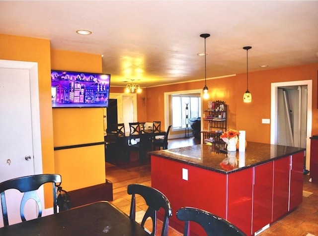 kitchen featuring a chandelier, hardwood / wood-style floors, a center island, and decorative light fixtures