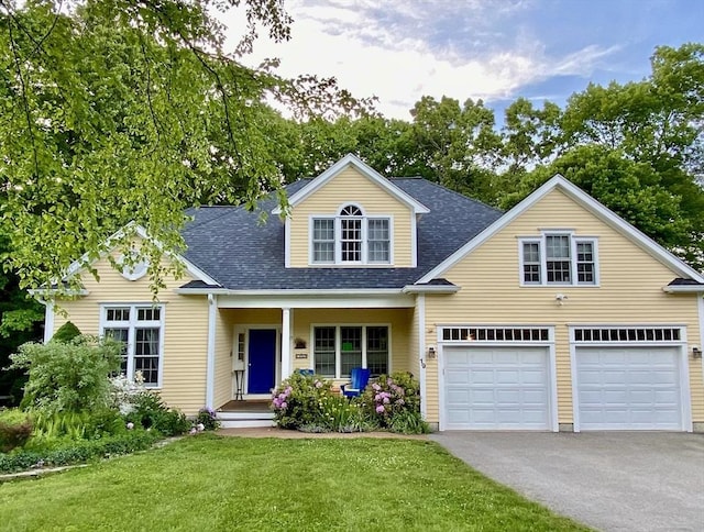 new england style home with a garage and a front yard