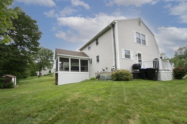 14 Robbins Rd, Ayer, MA 01432 - rear view of house with a sunroom and a lawn