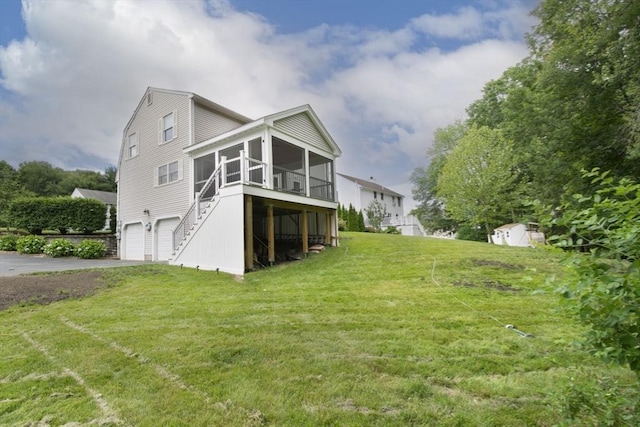 14 Robbins Rd, Ayer, MA 01432 - back of house featuring a sunroom, a garage, stairs, asphalt driveway, and a yard