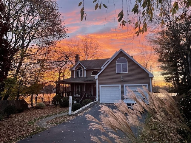2 Lake Ave, Framingham, MA 01702 - traditional-style house featuring driveway, an attached garage, a chimney, and a porch