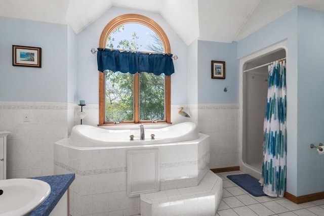 2 Lake Ave, Framingham, MA 01702 - full bathroom featuring tile walls, vanity, vaulted ceiling, tile patterned flooring, and plenty of natural light