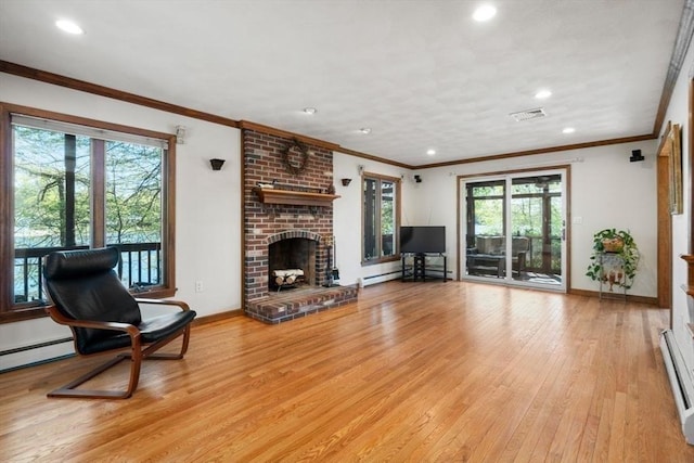 2 Lake Ave, Framingham, MA 01702 - living area with light wood-style floors, recessed lighting, a brick fireplace, baseboards, and crown molding