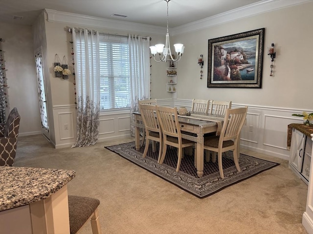 12101 Peters Farm Way Unit 12101, Westborough, MA 01581 - dining space with a decorative wall, a chandelier, light carpet, crown molding, and wainscoting